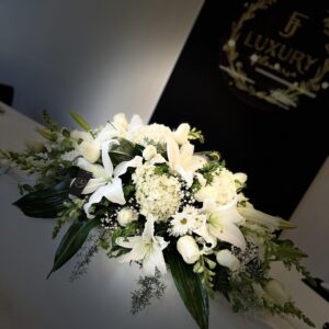 The Funeral Casket Arrangement honors a loved one with fresh flowers in chosen colors, offering beauty, comfort, and a heartfelt tribute.